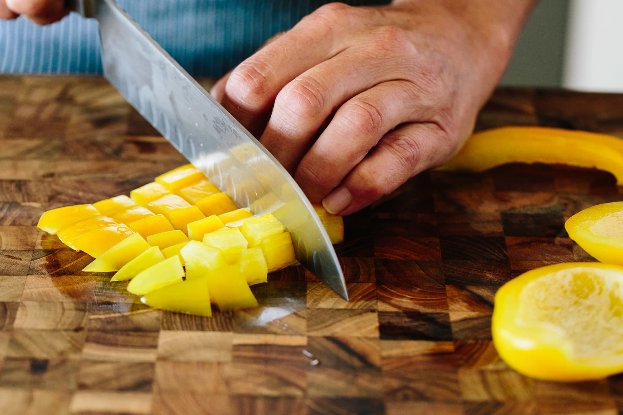 Why is a wet towel placed under the cutting board when cutting onions?